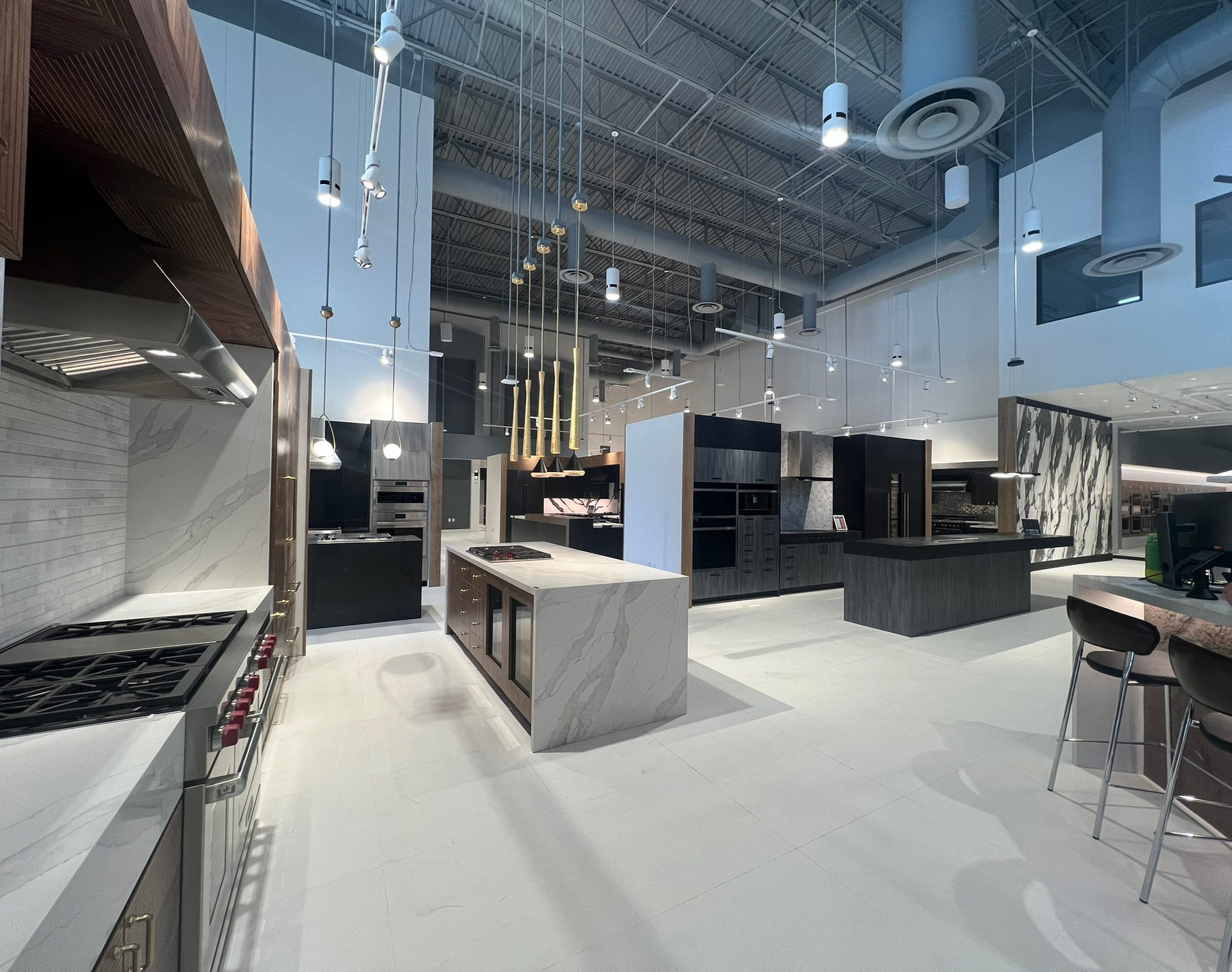 View from reception across the WDC La Quinta showroom with track and pendant lighting by Integration Techs