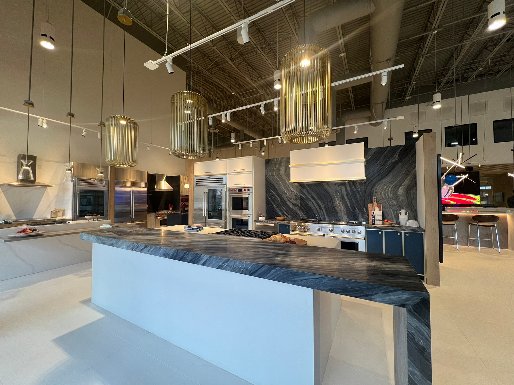 Kitchen vignette at WDC La Quinta with decorative pendants and track lighting supplied by Integration Techs