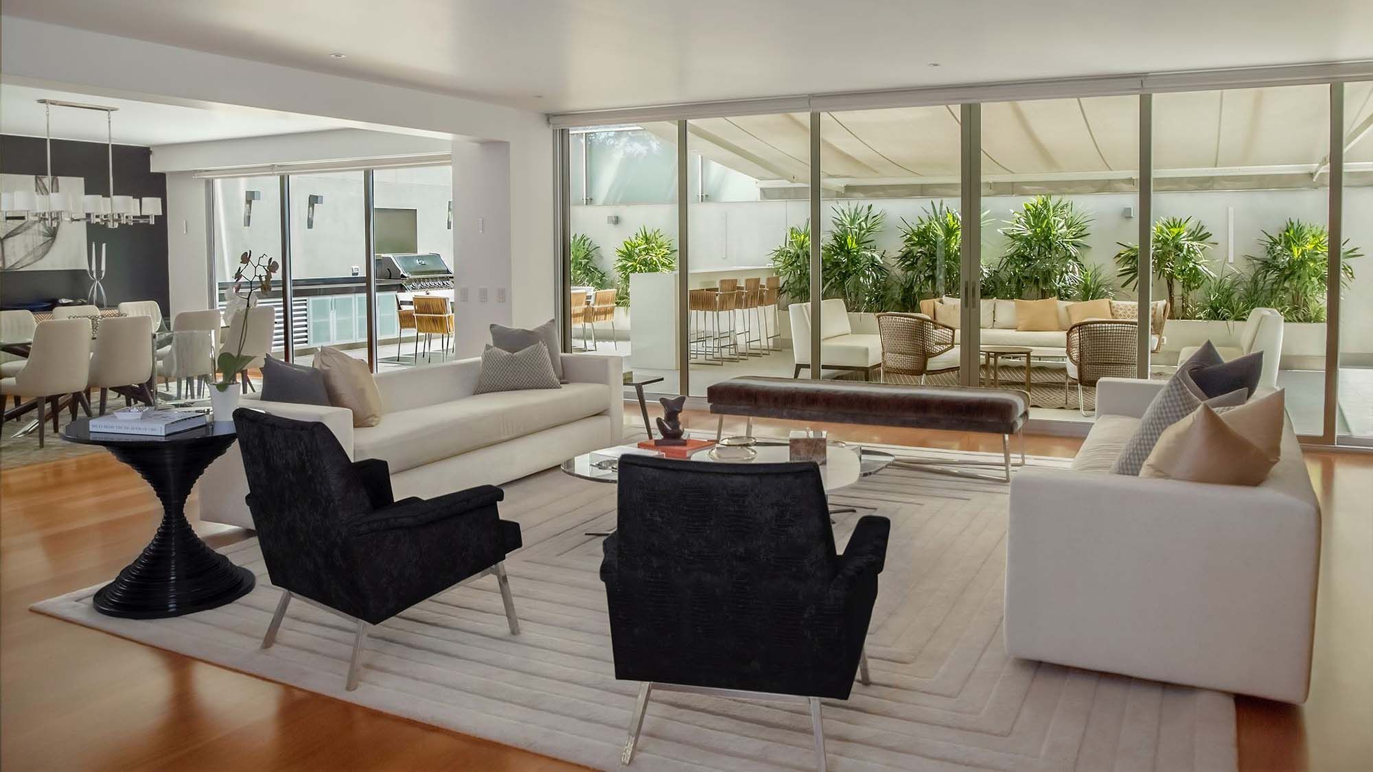 whole home image with speakers from k-array - white walls and floor to ceiling glass
