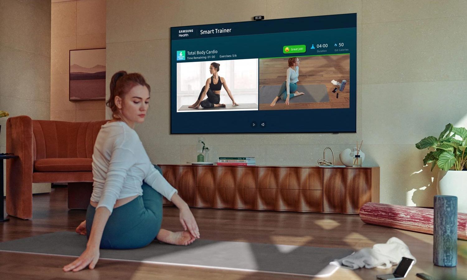 Woman practicing Yoga in an online class viewed in a Samsung TV